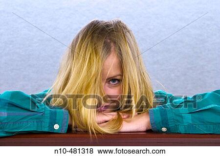 Young blond woman leaning on a ledge in an office building View Large Photo Image Stock Photo - Young blond woman leaning on a ledge in an office building. Fotosearch