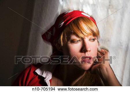 Young blond woman posing in front of a window View Large Photo Image Picture - Young blond woman posing in front of a window. Fotosearch