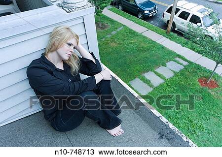 Young blond woman sitting on the roof of her house. View Large Photo Image Stock Image - Young blond woman sitting on the roof of her house.. Fotosearch