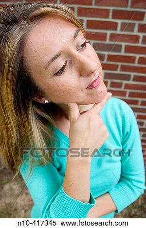 Young blond woman thinking and photographed up close, producing a mild distortion effect. View Large Photo Image Stock Photography - Young blond woman thinking and photographed up close, producing a mild distortion effect.. Fotosearch