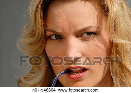 Picture - Young blond woman thinking.. Fotosearch