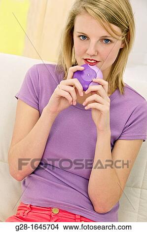 Young blond woman using an anti asthma inhaler View Large Photo Image Picture - Young blond woman using an anti asthma inhaler. Fotosearch