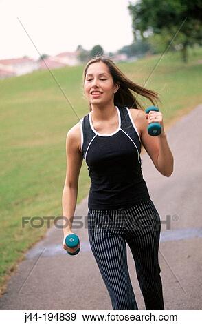 Young blond woman walking with weights View Large Photo Image Stock Photo - Young blond woman walking with weights. Fotosearch