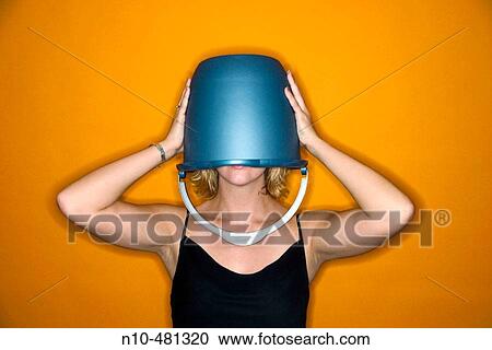 Young blond woman wearing a blue bucket on her head that covers her eyes View Large Photo Image Stock Image - Young blond woman wearing a blue bucket on her head that covers her eyes. Fotosearch