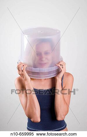 Young blond woman with a clear bucket covering her head. View Large Photo Image Stock Photography - Young blond woman with a clear bucket covering her head.. Fotosearch