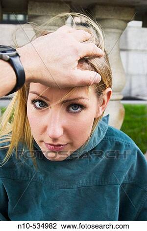 Young blond woman with a man's hand resting on her head View Large Photo Image Stock Image - Young blond woman with a man's hand resting on her head. Fotosearch