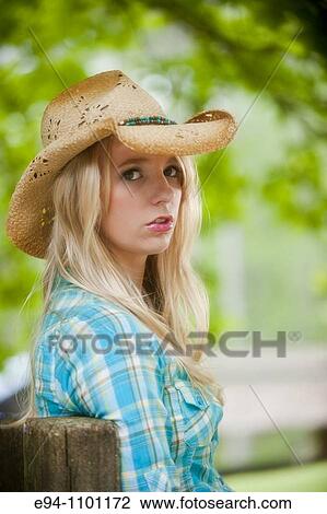 Young blond woman with a straw hat in a country outdoor setting looking directly at camera. View Large Photo Image Stock Image - Young blond woman with a straw hat in a country outdoor setting looking directly at camera.. Fotosearch