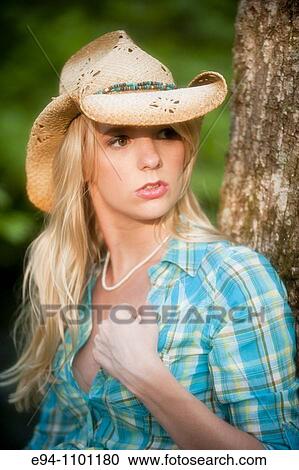 Young blond woman with a straw hat in a country outdoor setting View Large Photo Image Stock Image - Young blond woman with a straw hat in a country outdoor setting. Fotosearch