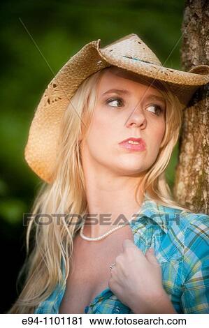 Young blond woman with a straw hat in a country outdoor setting View Large Photo Image Stock Image - Young blond woman with a straw hat in a country outdoor setting. Fotosearch