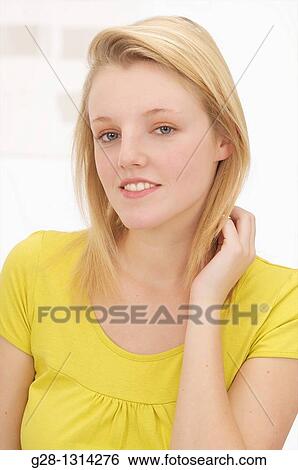 Young blond woman with long hair and smiling View Large Photo Image Stock Photograph - Young blond woman with long hair and smiling. Fotosearch
