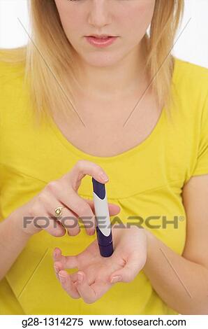 Young blond woman with long hair checking her glucose in her blood for Diabetes problems detail View Large Photo Image Stock Photography - Young blond woman with long hair checking her glucose in her blood for Diabetes problems detail. Fotosearch