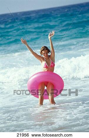 Young blond woman with rubber ring around waist in the beach, Venezuela View Large Photo Image Stock Photograph - Young blond woman with rubber ring around waist in the beach, Venezuela. Fotosearch