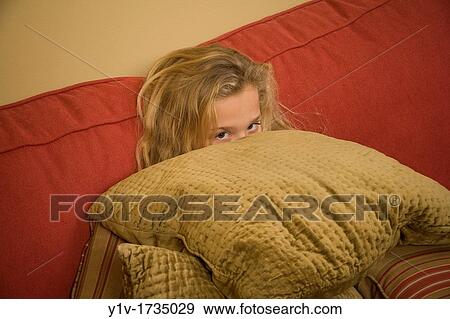 Young blonde girl behind a pile of pillows View Large Photo Image Stock Photo - Young blonde girl behind a pile of pillows. Fotosearch