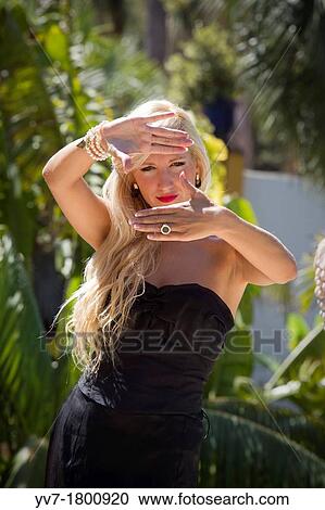 young blonde girl posing in a garden View Large Photo Image Stock Image - young blonde girl posing in a garden. Fotosearch