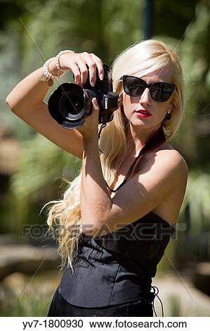 Young blonde girl taking pictures in the Molino de Inca Botanical Garden View Large Photo Image Stock Image - Young blonde girl taking pictures in the Molino de Inca Botanical Garden. Fotosearch