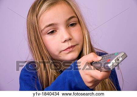Young blonde girl with a remote control View Large Photo Image Picture - Young blonde girl with a remote control. Fotosearch