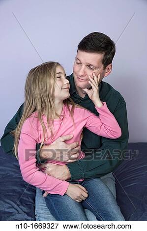Stock Photo - Young blonde girl with her father. Fotosearch