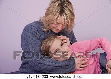 Young blonde girl with her mother View Large Photo Image Stock Image - Young blonde girl with her mother. Fotosearch