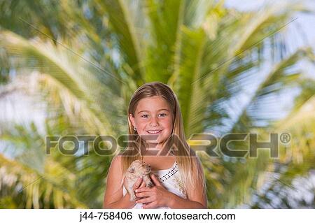 Young blonde girl with new born poodle puppy outdoors, smiling, portrait View Large Photo Image Stock Photograph - Young blonde girl with new born poodle puppy outdoors, smiling, portrait. Fotosearch