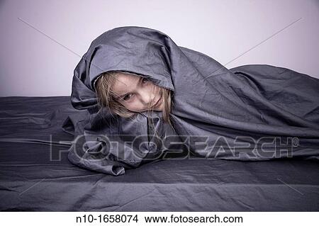 Young blonde girl with the bed sheet around her View Large Photo Image Picture - Young blonde girl with the bed sheet around her. Fotosearch