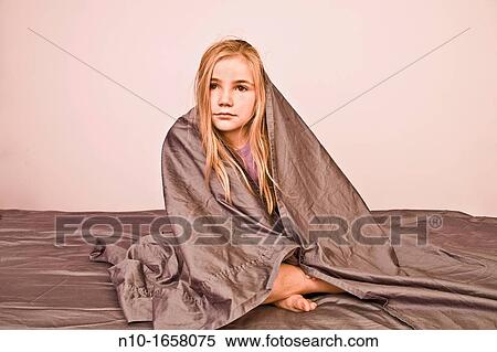 Young blonde girl with the bed sheet around her View Large Photo Image Stock Photography - Young blonde girl with the bed sheet around her. Fotosearch