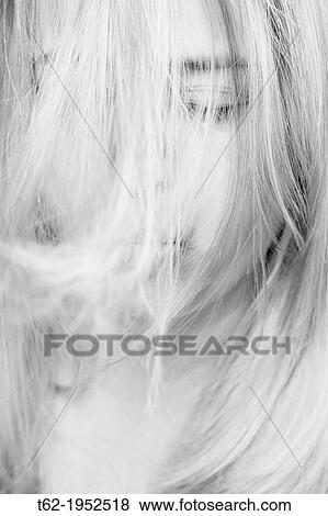 Young blonde with her hair in the face. View Large Photo Image Stock Photo - Young blonde with her hair in the face.. Fotosearch