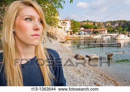 Young blonde woman at a seaside View Large Photo Image Picture - Young blonde woman at a seaside. Fotosearch