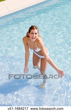 Young blonde woman having fun at the pool View Large Photo Image Stock Photo - Young blonde woman having fun at the pool. Fotosearch