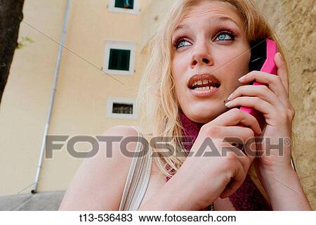 Young blonde woman in telephone booth talks to someone View Large Photo Image Stock Image - Young blonde woman in telephone booth talks to someone. Fotosearch