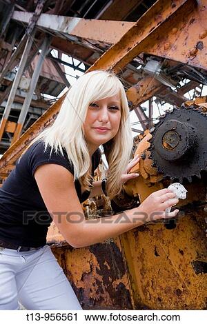 Young blonde woman is cleaning a piece of machinery View Large Photo Image Stock Image - Young blonde woman is cleaning a piece of machinery. Fotosearch