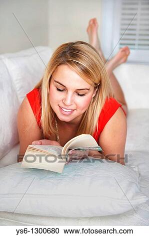 Young blonde woman reading on couch. View Large Photo Image Stock Image - Young blonde woman reading on couch.. Fotosearch