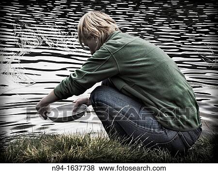Young blonde woman washing dishes in aluminum river. View Large Photo Image Stock Photo - Young blonde woman washing dishes in aluminum river.. Fotosearch