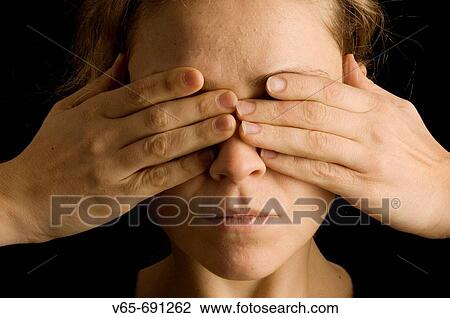 Young blonde woman with her hands covering her eyes View Large Photo Image Stock Image - Young blonde woman with her hands covering her eyes. Fotosearch