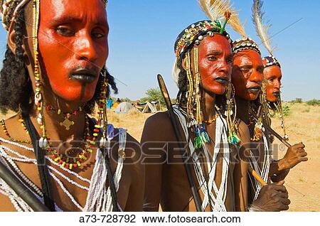 Stock Image - Young Bororo men preparing for traditional dance during the Gerewol festival, the most important meeting for Bororo tribe, Niger. Fotosearch