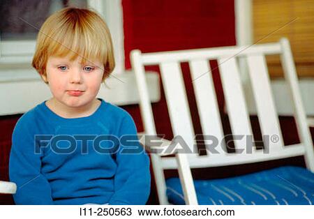 Young boy (4-6 years old) sitting on porch View Large Photo Image Stock Image - Young boy (4-6 years old) sitting on porch. Fotosearch