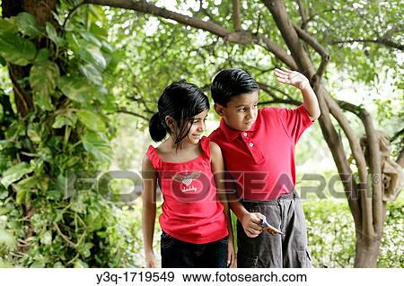 young boy and girl share a happy childhood moment together View Large Photo Image Stock Photo - young boy and girl share a happy childhood moment together. Fotosearch