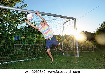Young boy as goalkeeper playing soccer on a meadow, Germany. View Large Photo Image Stock Image - Young boy as goalkeeper playing soccer on a meadow, Germany.. Fotosearch