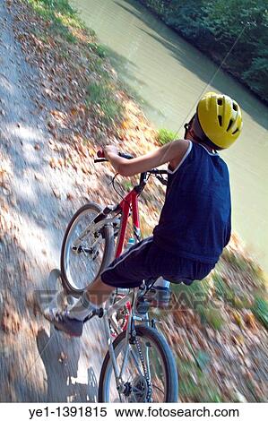 Young boy biking, Carcassonne, Canal du Midi, France View Large Photo Image Stock Photography - Young boy biking, Carcassonne, Canal du Midi, France. Fotosearch
