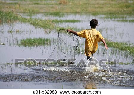 Young boy catching small fishes with a home made net. River Nile between Qena and Luxor. Upper Egypt View Large Photo Image Stock Image - Young boy catching small fishes with a home made net. River Nile between Qena and Luxor. Upper Egypt. Fotosearch