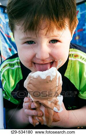 Young boy eating an ice cream View Large Photo Image Stock Image - Young boy eating an ice cream. Fotosearch