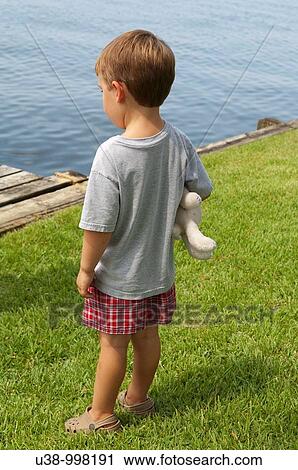 Young boy gazing out to the water View Large Photo Image Stock Image - Young boy gazing out to the water. Fotosearch