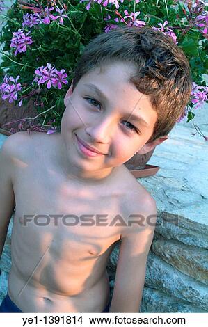 Young boy in a garden at sunset, France View Large Photo Image Picture - Young boy in a garden at sunset, France. Fotosearch