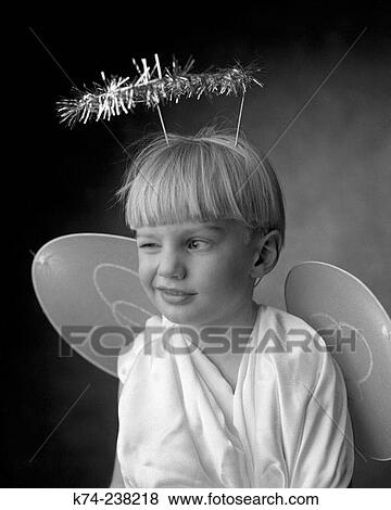 Stock Photo - Young Boy In Angel Costume Winking. Fotosearch