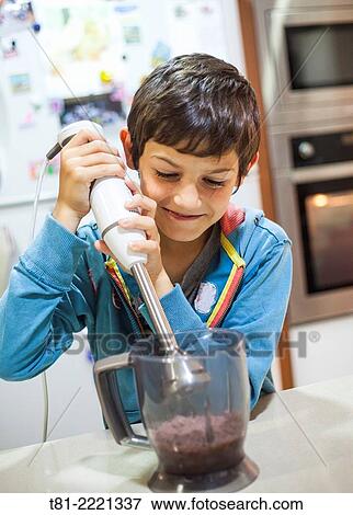 Young boy learning to cook, in the kitchen Valencia, Spain,. View Large Photo Image Stock Photo - Young boy learning to cook, in the kitchen Valencia, Spain,.. Fotosearch