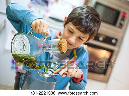 Young boy learning to cook, in the kitchen Valencia, Spain,. View Large Photo Image Stock Photograph - Young boy learning to cook, in the kitchen Valencia, Spain,.. Fotosearch