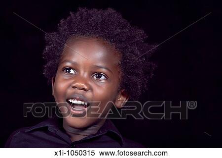 Stock Photography - Young boy looking surprised. Fotosearch