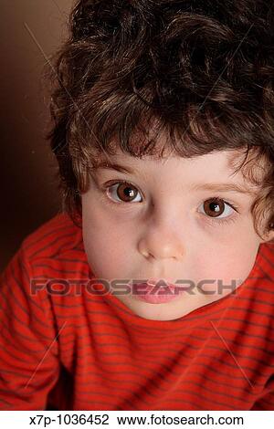 Stock Image - Young boy looking up. Fotosearch