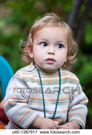 Stock Photo - Young boy looking up. Fotosearch