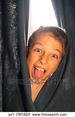 Young boy making a silly face and sticking out his tongue, France View Large Photo Image Picture - Young boy making a silly face and sticking out his tongue, France. Fotosearch