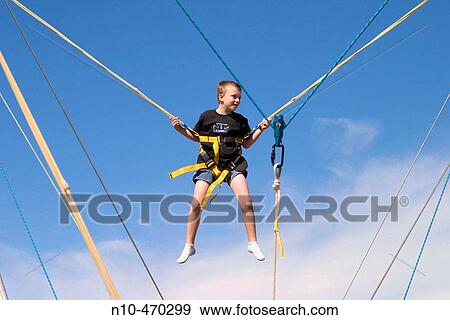 Young boy on a bungee cord ride at a fair in Connecticut, USA View Large Photo Image Stock Photo - Young boy on a bungee cord ride at a fair in Connecticut, USA. Fotosearch